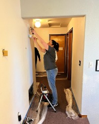 Woman painting a wall
