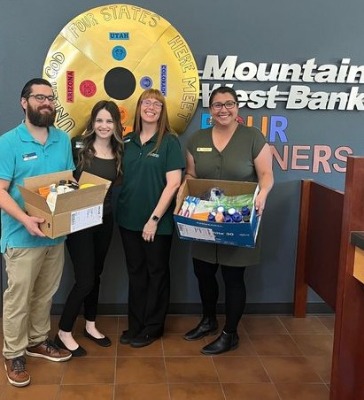 Group of people with boxes of summer supply needs for charity