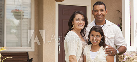 Happy family in front of residence photo