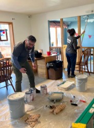 2 people painting room inside house