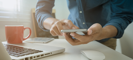 Woman using her cell phone to bank online.